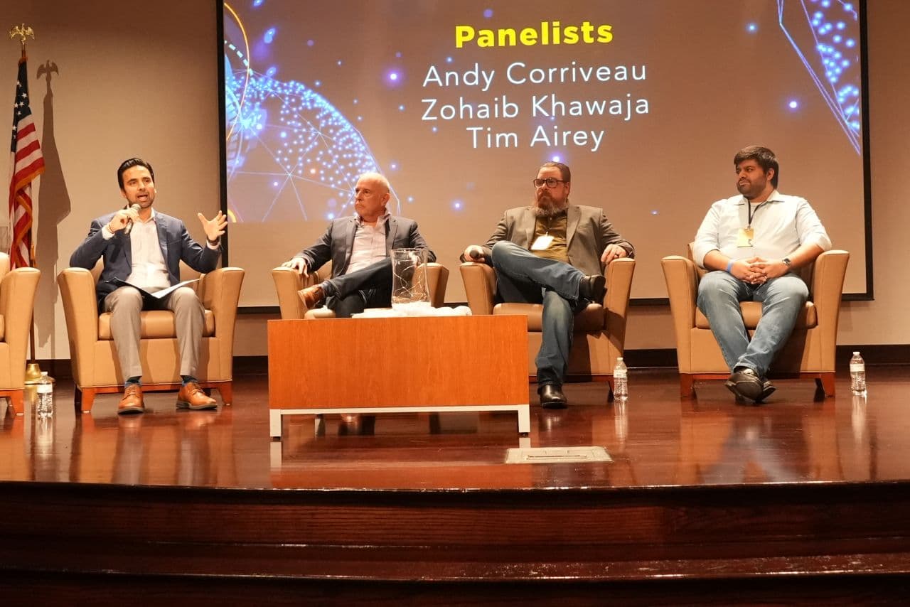 Zohaib Khawaja participating in a panel discussion on stage